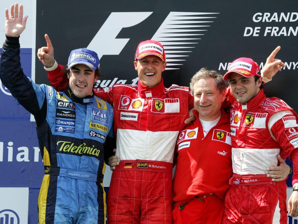 Ferrari Formula One driver Michael Schumacher of Germany, second left, poses on the podium after winning the French Formula One Grand Prix.