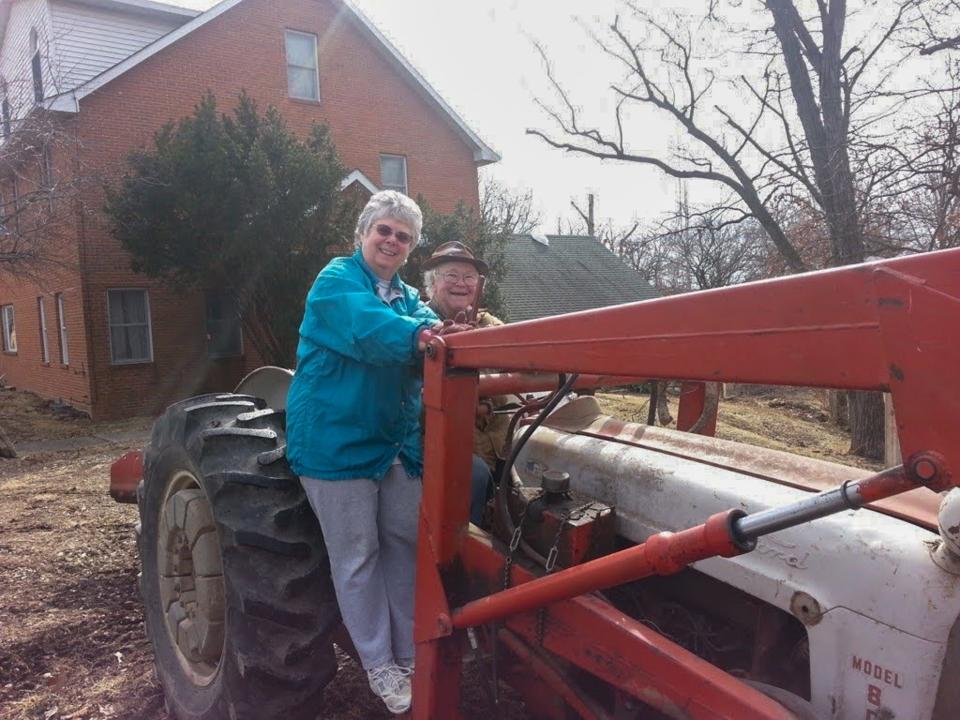 Patricia and Ned Glenn, the grandparents of St. Cloud Times sports reporter Reid Glenn, pose on a parked tractor at their house outside of Louisiana, Missouri.