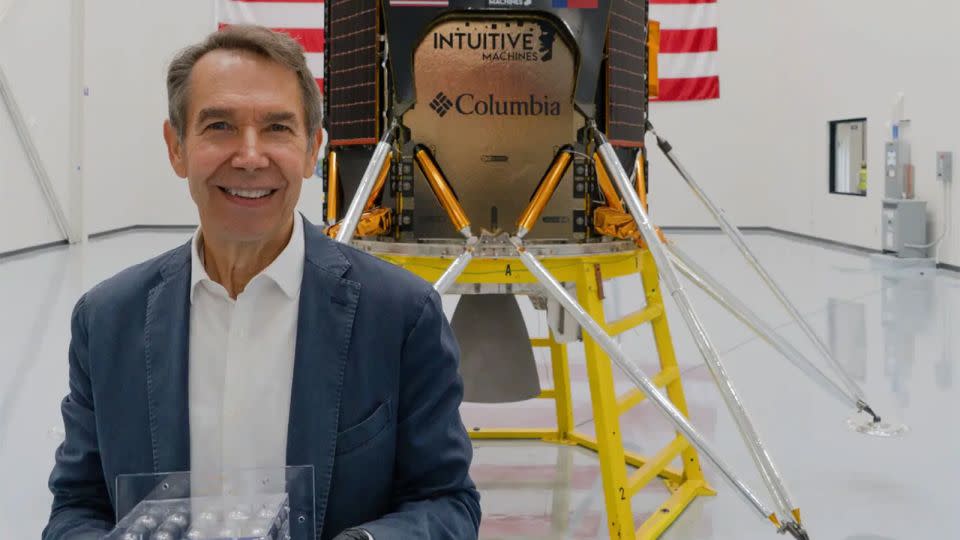 Jeff Koons poses with his moon-bound artwork. - From Jeff Koons/Instagram