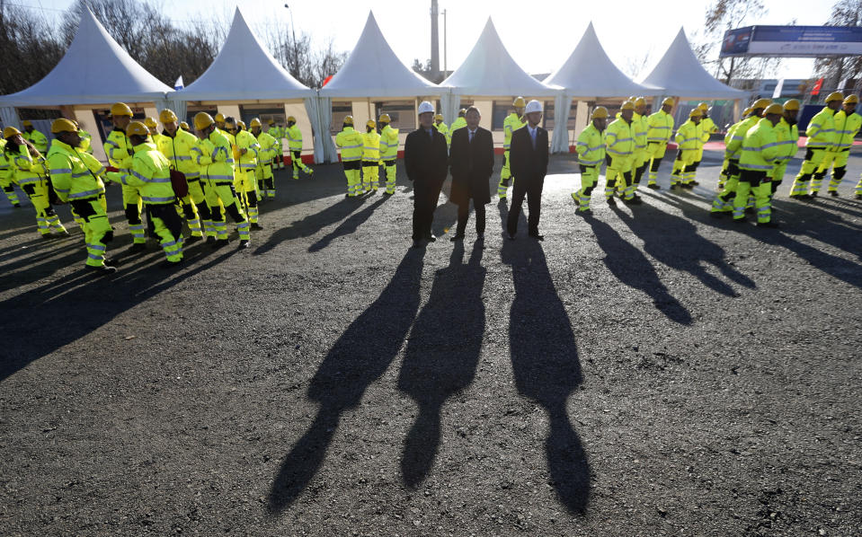 FILE - Workers and officials await the ceremony of the reconstruction of a railway line between Budapest and Belgrade, in Belgrade, Serbia, on Nov. 28, 2017. Reconstruction of a railway line between Budapest and Belgrade, a project financed mainly by China, as a "flagship project" of China's increased presence in the region. Serbia has been a loyal ally that opened its door without restraint to billions of dollars of Chinese investment, despite formally seeking European Union membership. (AP Photo/Darko Vojinovic, File)