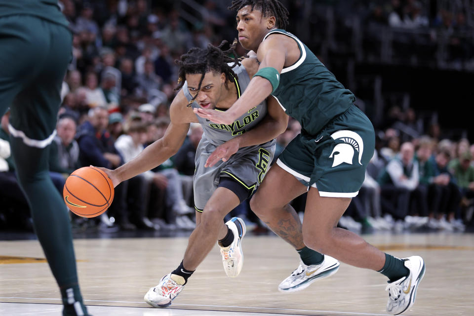 Baylor guard Jayden Nunn, left, drives against Michigan State guard Jeremy Fears Jr. during the second half of an NCAA college basketball game, Saturday, Dec. 16, 2023, in Detroit. Michigan State won 88-64. (AP Photo/Al Goldis)