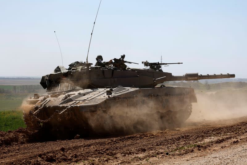 An Israeli tank maneuvers near Israel's border with Gaza, amid the ongoing conflict between Israel and the Palestinian Islamist group Hamas, in southern Israel