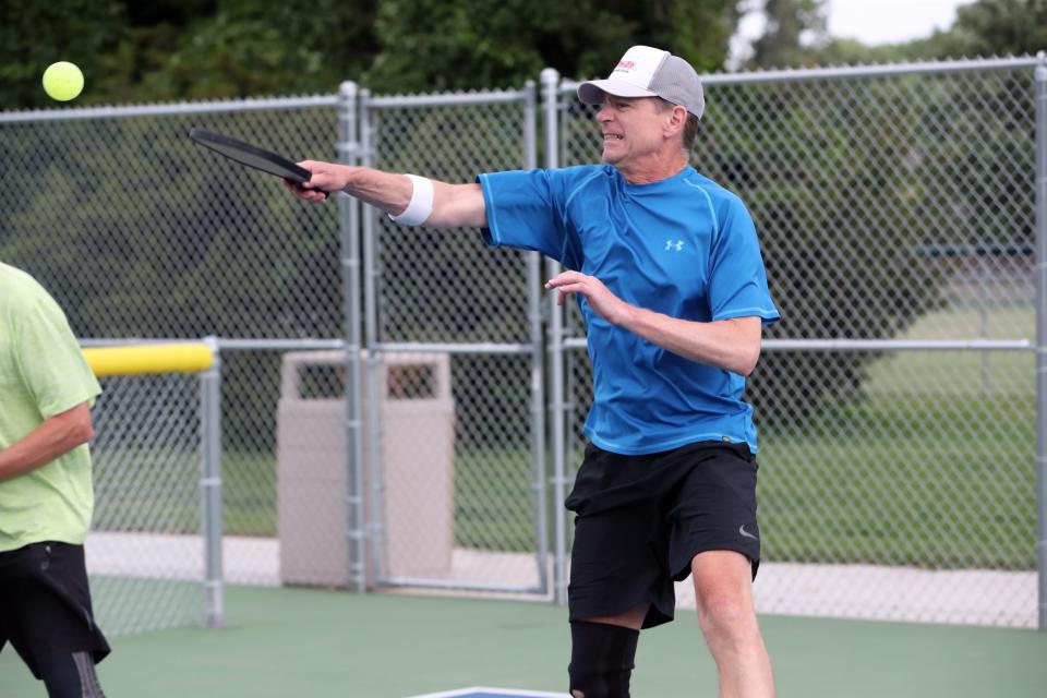 Wes Lindquist strikes the ball during a volley during a pickleball match June 30 at Manor Park.