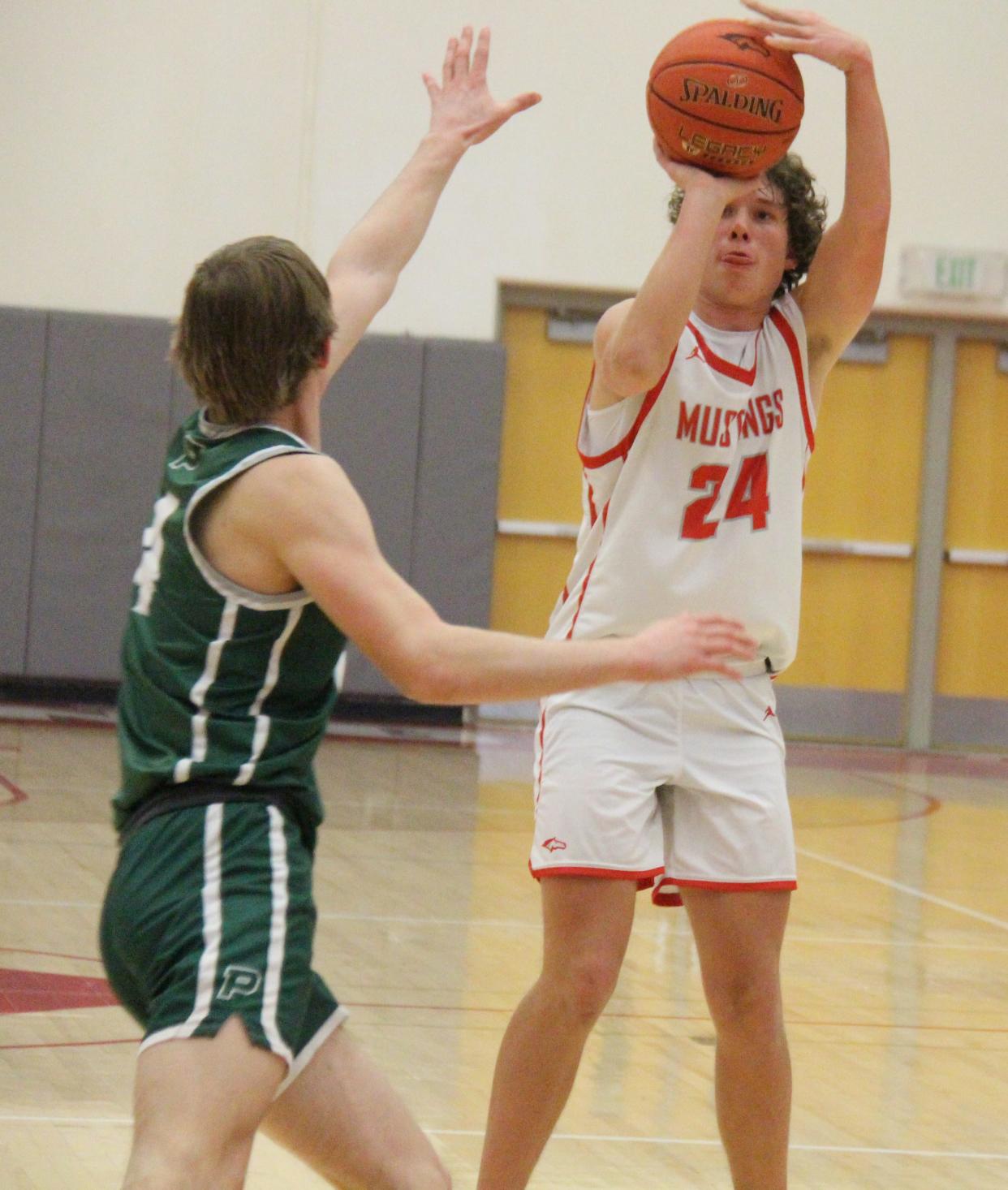 DCG's Jonathan Howard shoots a three-pointer during a game against Pella on Friday, Feb. 10, 2023, in Grimes.