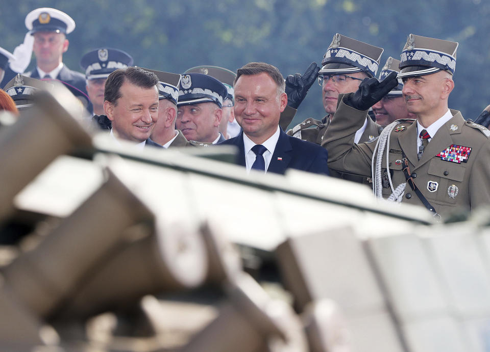 Poland's president Andrzej Duda, center, looks on during the annual Armed Forces review during a national holiday, in Katowice, Poland, Thursday, Aug. 15, 2019. Large crowds turned out for the celebration which this year included a fly-over by two U.S. F-15 fighter jets.(AP Photo/Czarek Sokolowski)