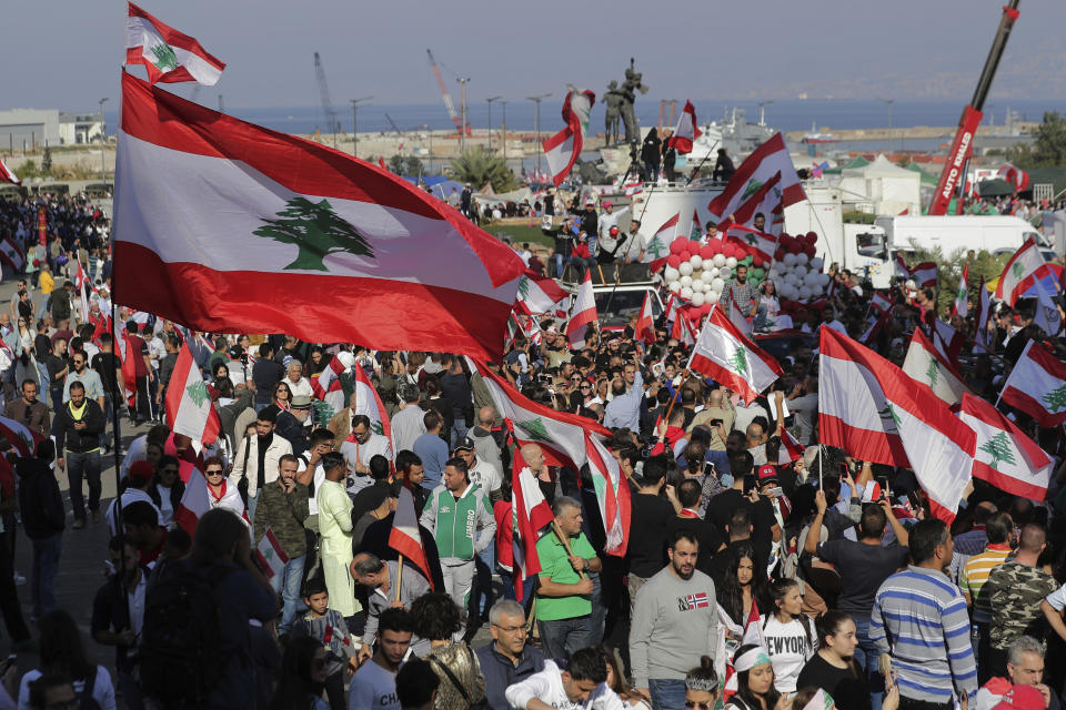 Anti-government protesters gather during separate civil parade at the Martyr square, in downtown Beirut, Lebanon, Friday, Nov. 22, 2019. Protesters gathered for their own alternative independence celebrations, converging by early afternoon on Martyrs' square in central Beirut, which used to be the traditional location for the official parade. Protesters have occupied the area, closing it off to traffic since mid-October. (AP Photo/Hassan Ammar)