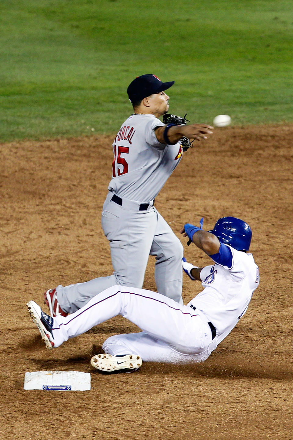 ARLINGTON, TX - OCTOBER 22: Rafael Furcal #15 of the St. Louis Cardinals turns the double play as Elvis Andrus #1 of the Texas Rangers slides into second base in the sixth inning during Game Three of the MLB World Series at Rangers Ballpark in Arlington on October 22, 2011 in Arlington, Texas. (Photo by Tom Pennington/Getty Images)