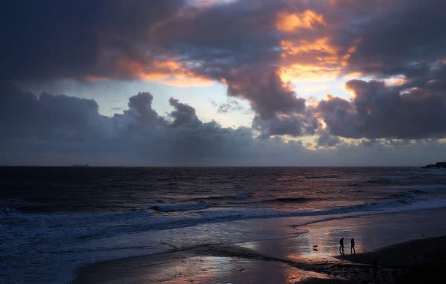 It was a chilly start for walkers on Whitley Bay beach, North Tyneside (Owen Humphreys/PA)