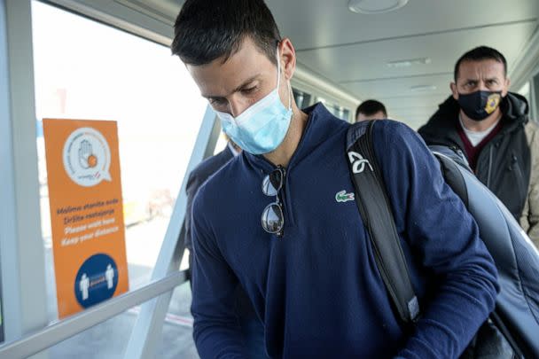 PHOTO: Novak Djokovic looks as his documents after landing in Belgrade, Serbia, Monday, Jan. 17, 2022. (Darko Bandic/AP, FILE)