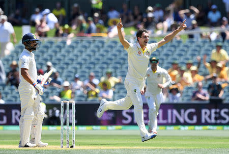 Australian bowler Pat Cummins reacts after dismissing Indian batsman Virat Kohli for 3 runs during day one of the first test match between Australia and India at the Adelaide Oval in Adelaide, Australia, December 6, 2018. AAP/Dave Hunt/via REUTERS