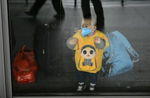 This young Shanghai subway passenger is taking the same precautions adults do for protection against the deadly virus