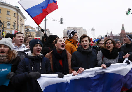 FILE PHOTO: Supporters of Russian opposition leader Alexei Navalny shout slogans during a rally for a boycott of a March 18 presidential election in Moscow, Russia January 28, 2018. REUTERS/Maxim Shemetov/File Photo