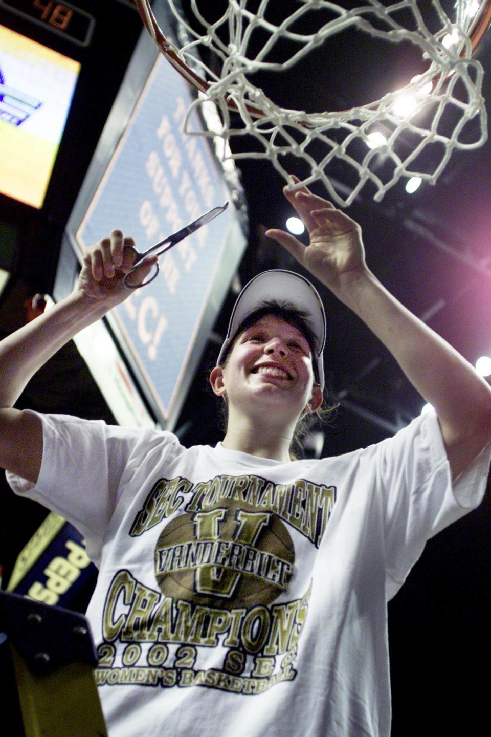 Vanderbilt's Zuzi Klimesova cuts away a piece of the net after the Lady Commodores beat LSU 63-48 for the SEC Women's Championships title at the Gaylord Entertainment Center in Nashville March 3, 2002. Klimesova was the tournament MVP.