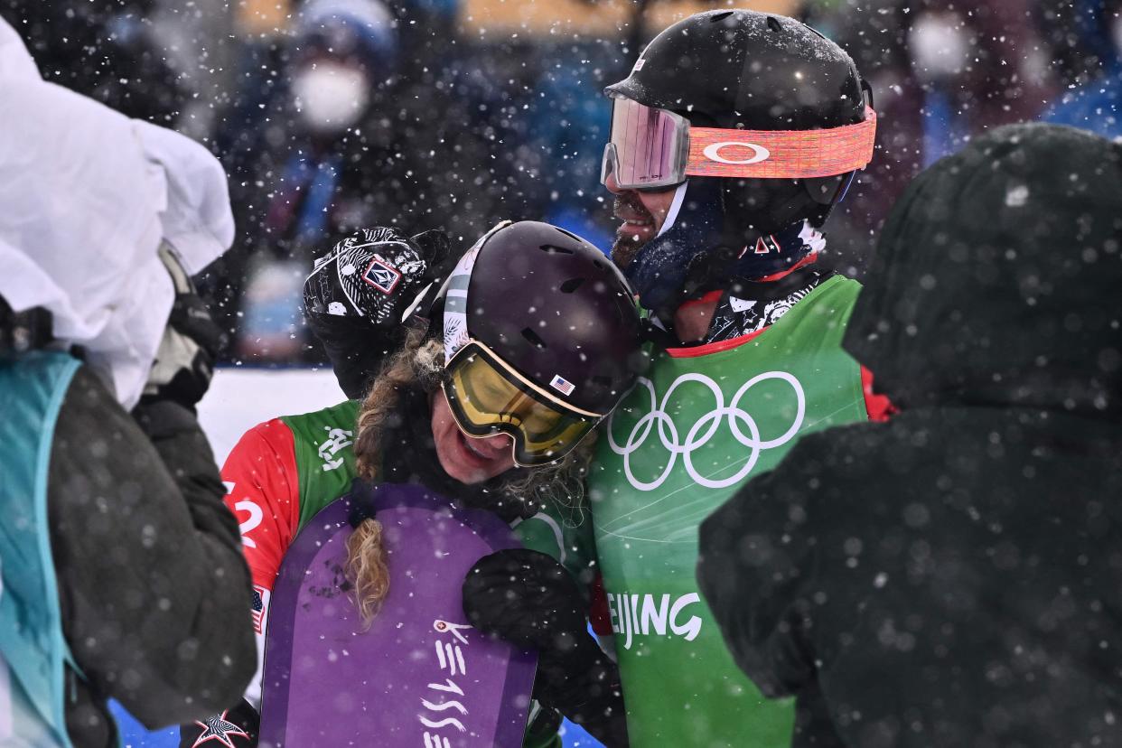 USA's Nick Baumgartner (R) and USA's Lindsey Jacobellis react after their snowboardcross mixed quarterfinals during the 2022 Winter Olympics at the Genting Snow Park P & X Stadium in Zhangjiakou, China on Feb. 12, 2022.