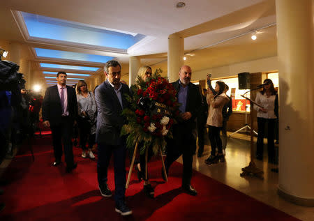 REFILE - CORRECTING GRAMMAR Members of Rosario's City council carry flowers during a ceremony in honour of the five Argentine citizens of Rosario who were killed in the truck attack in New York on October 31, at the National Flag Memorial in Rosario, Argentina November 2, 2017. REUTERS/Marcos Brindicci