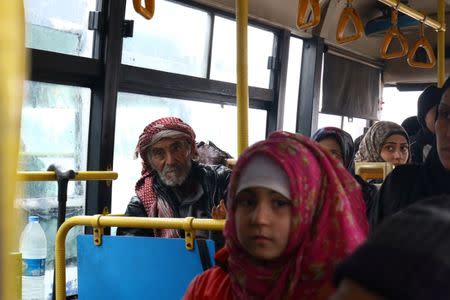 Evacuees from the Shi'ite Muslim villages of al-Foua and Kefraya ride a bus at insurgent-held al-Rashideen in the province of Aleppo, Syria December 22, 2016. REUTERS/Ammar Abdullah