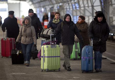 People leave a departure lounge after Royal Caribbean's cruise ship, Explorer of the Seas arrived back at Bayonne, New Jersey January 29, 2014. REUTERS/Carlo Allegri
