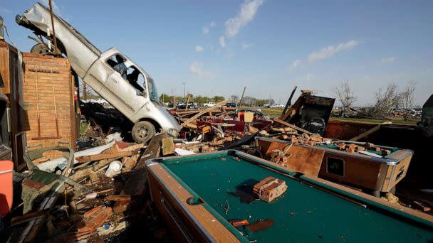 PHOTO: A pickup truck rests on top of a restaurant cooler at the tornado demolished Chuck's Dairy Cafe in Rolling Fork, Miss., Mar. 25, 2023. (Rogelio V. Solis/AP)