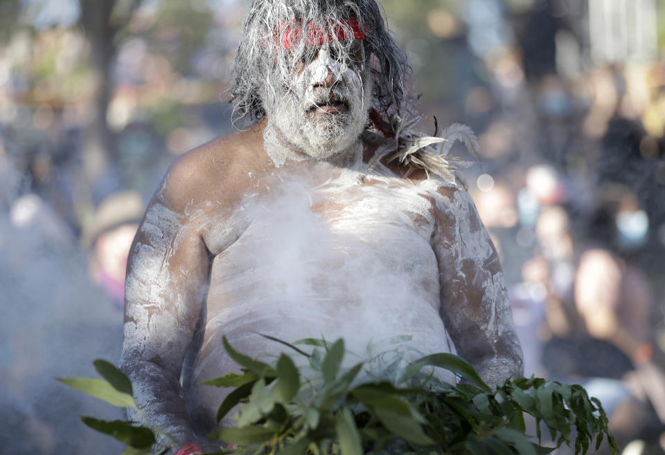 A member of the Koomurri Aboriginal Dancers participates in a smoking ceremony during Australia Day ceremonies in Sydney, Tuesday, Jan. 26, 2021. (AP Photo/Rick Rycroft)