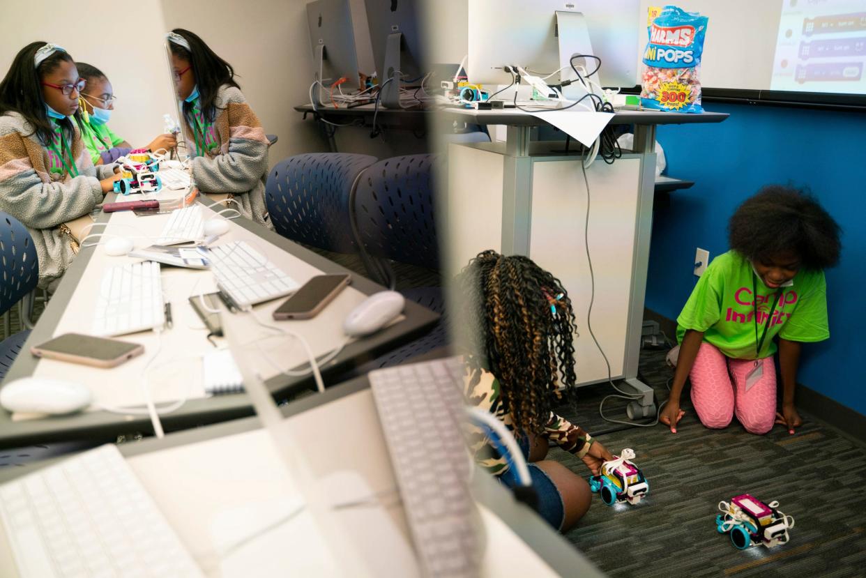 8th grader Jaiya Brewster, 12, left, 8th grader Tatianna Williams, 13, and 7th grader Shanajia Sheppard, 11, race lego robots they programed during a Camp Infinity workshop hosted by the Michigan Council of Women in Technology Foundation at Wayne County Community College Center for Learning Technology in Harper Woods on Wednesday, July 13, 2022.