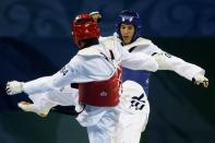 Mark Lopez (blue) of the U.S. fights Daniel Manz of Germany during the men's -68kg quarterfinal taekwando competition at the Beijing 2008 Olympic Games, August 21, 2008. REUTERS/Alessandro Bianchi/File Photo