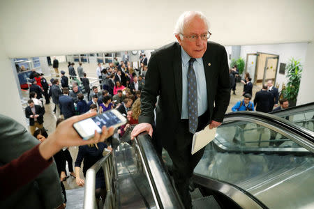 Reporters trail U.S. Senator Bernie Sanders (I-VT) as he arrives ahead of a vote on a bill to renew the National Security Agency's warrantless internet surveillance program, at the U.S. Capitol in Washington, U.S. January 18, 2018. REUTERS/Jonathan Ernst