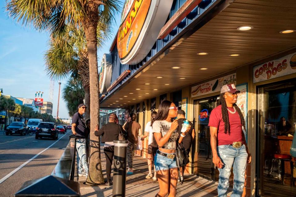 Tourists fill the sidewalk outside Peaches Corner in downtown Myrtle Beach on Friday. Grand strand residents and visitors head for the beach on the first sunny weekend of Spring. March 24, 2023.