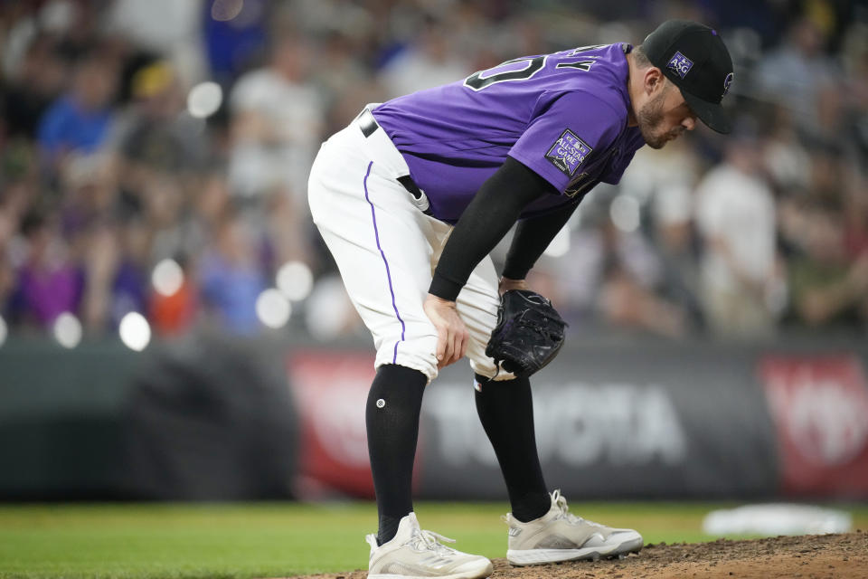 Colorado Rockies relief pitcher Tyler Kinley reacts after giving up a two-run home run to Milwaukee Brewers' Willy Adames during the ninth inning of a baseball game Saturday, June 19, 2021, in Denver. (AP Photo/David Zalubowski)