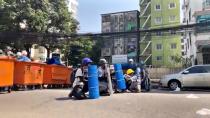 Protesters hide behind barricades during an anti-coup protest in Yangon, Myanmar