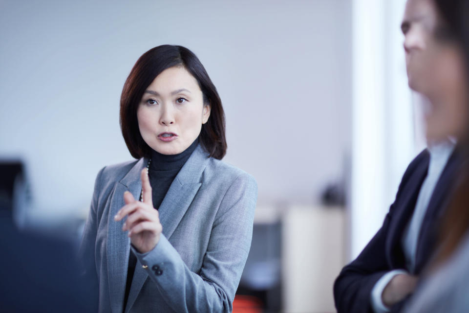 Businesswoman gesturing and explaining in meeting