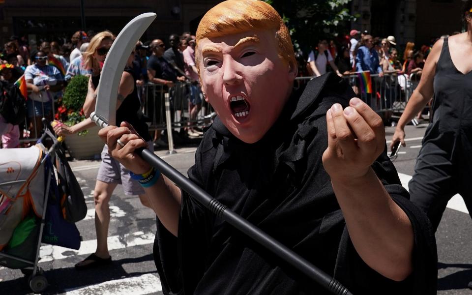 A person dressed up as U.S. President Donald Trump in the Grim Reaper outfit participates in the LGBT Pride March in Manhatten - Credit: Reuters