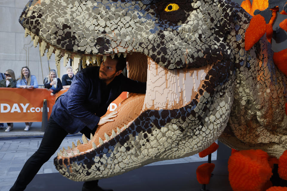 Pratt clowns around with a Lego T. rex on the Today show. (Photo by Jason DeCrow/Invision for NBCUniversal and LEGO/AP Images)