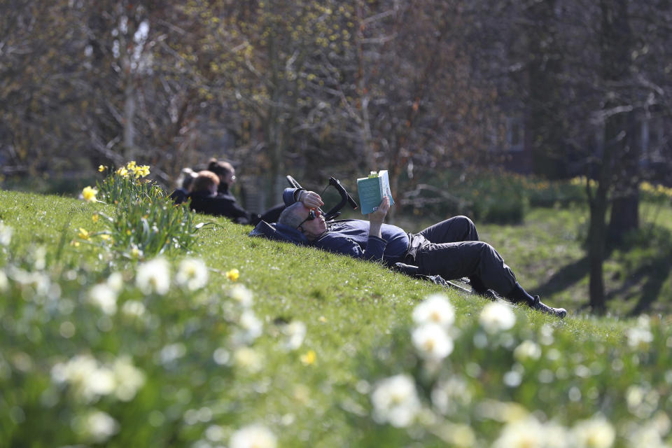 People enjoy the sunny weather in Sefton Park in Liverpool, England, Sunday April 4, 2021. During current coronavirus restrictions people are allowed to meet up and exercise in the open air. (Peter Byrne/PA via AP)