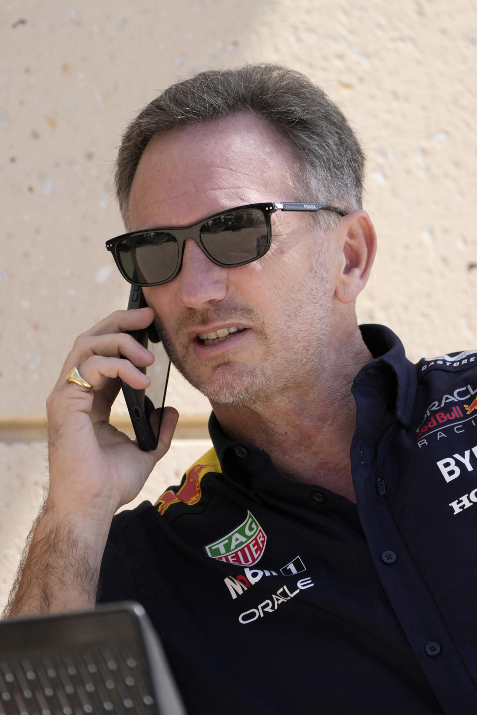 Red Bull team principal Christian Horner speaks on a mobile phone prior to the first practice session ahead of the Formula One Bahrain Grand Prix at the Bahrain International Circuit in Sakhir, Bahrain, Thursday, Feb. 29, 2024. (AP Photo/Darko Bandic)