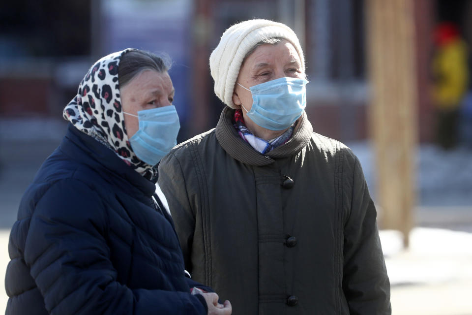 MOSCOW, RUSSIA - MARCH 16, 2020: Two elderly women wearing medical masks in a street. Stanislav Krasilnikov/TASS (Photo by Stanislav Krasilnikov\TASS via Getty Images)