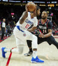 Los Angeles Clippers guard Paul George, left, keeps the ball away from Portland Trail Blazers forward Norman Powell during the first half of an NBA basketball game in Portland, Ore., Monday, Dec. 6, 2021. (AP Photo/Craig Mitchelldyer)