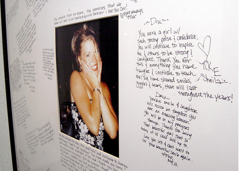 FILE - In this Nov. 18, 2004 file photo, a memorial with a photo of Dru Sjodin and handwritten notes from fellow sorority members hangs in the entry of the Gamma Phi Beta house on the campus of the University of North Dakota in Grand Forks, N.D. A federal judge on Friday, Sept. 3, 2021, threw out the death sentence for Alfonso Rodriguez Jr convicted in the 2003 slaying of Dru Sjodin, a North Dakota college student. (AP Photo/Kory Wallen, File)