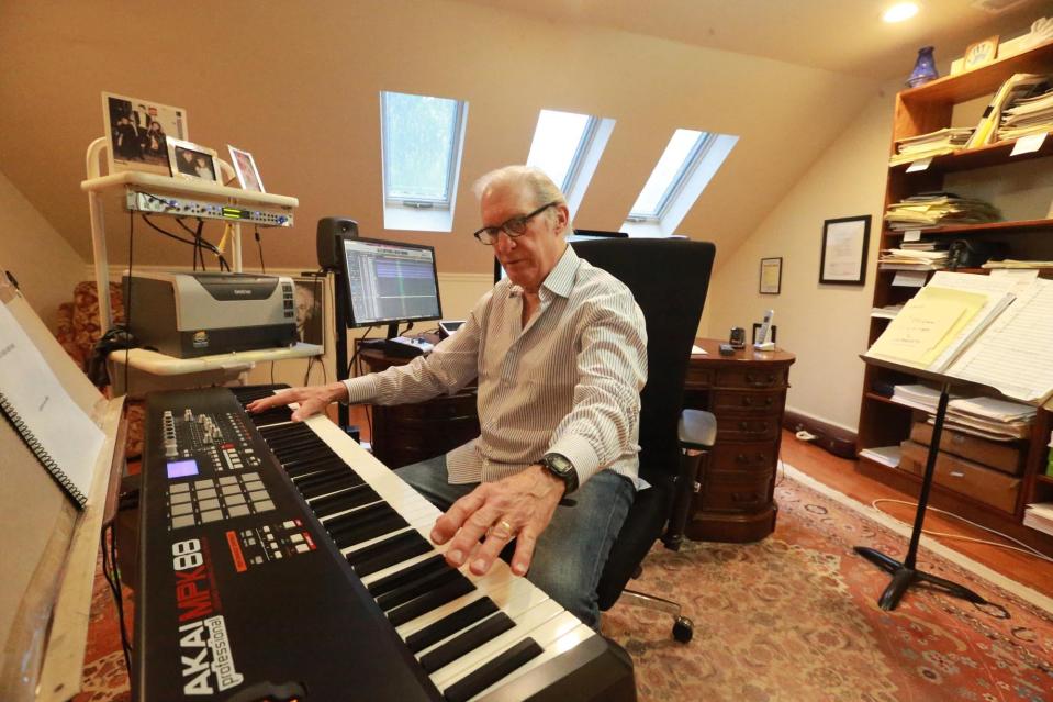 Composer Richard Sortomme plays the keyboard in his home studio. A recent video by Sortomme focused on the composing process.