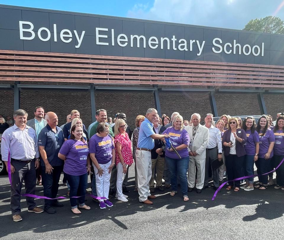 Ouachita Parish School Board Member Tommy Comeaux and Boley Elementary principal Sandy Bates cut the ribbon at the ribbon cutting ceremony for the school's new facility on Thursday.