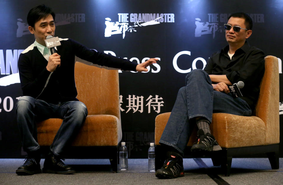 Tony Leung, left, speaks while movie director Wong Kar-wai listens during a press conference on Wednesday, Jan. 23, 2013 in Singapore. For a director and actor who have worked together for about two decades, there did not seem to be much chemistry between Wong and Leung at the news conference promoting their new movie "The Grandmaster." (AP Photo/Wong Maye-E)