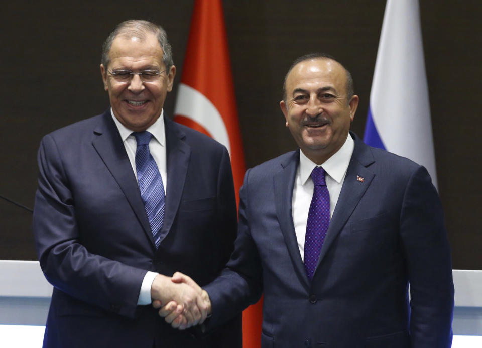 Turkey's Foreign Minister Mevlut Cavusoglu, right, and his Russian counterpart Sergei Lavrov shake hands after a news conference in the Mediterranean coastal city of Antalya, Turkey, Friday, March 29, 2019. Turkey's foreign minister said Friday his country is committed to a deal to purchase advanced Russian surface-to-air missile defense system, despite warnings from Washington that the deal could put the NATO member country's participation in the U.S. F-35 fighter aircraft program at risk. (Turkish Foreign Ministry via AP, Pool)