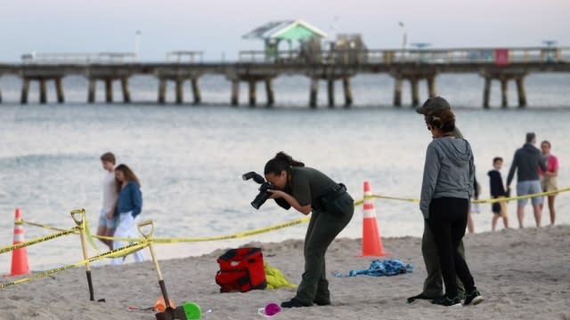 Investigators on the beach in Lauderdale-by-the-Sea, Fla.