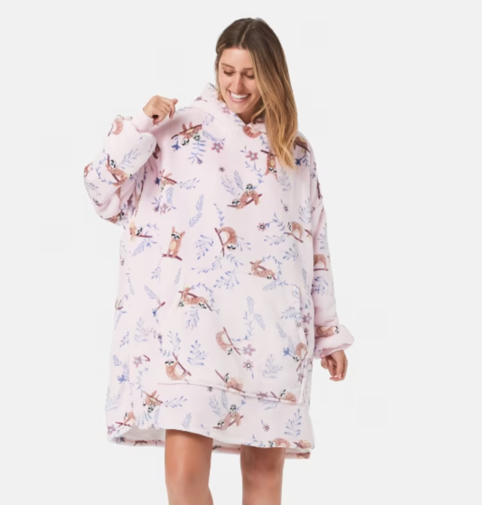 Woman wears Kmart dupe of the Oodie in a sloth print 