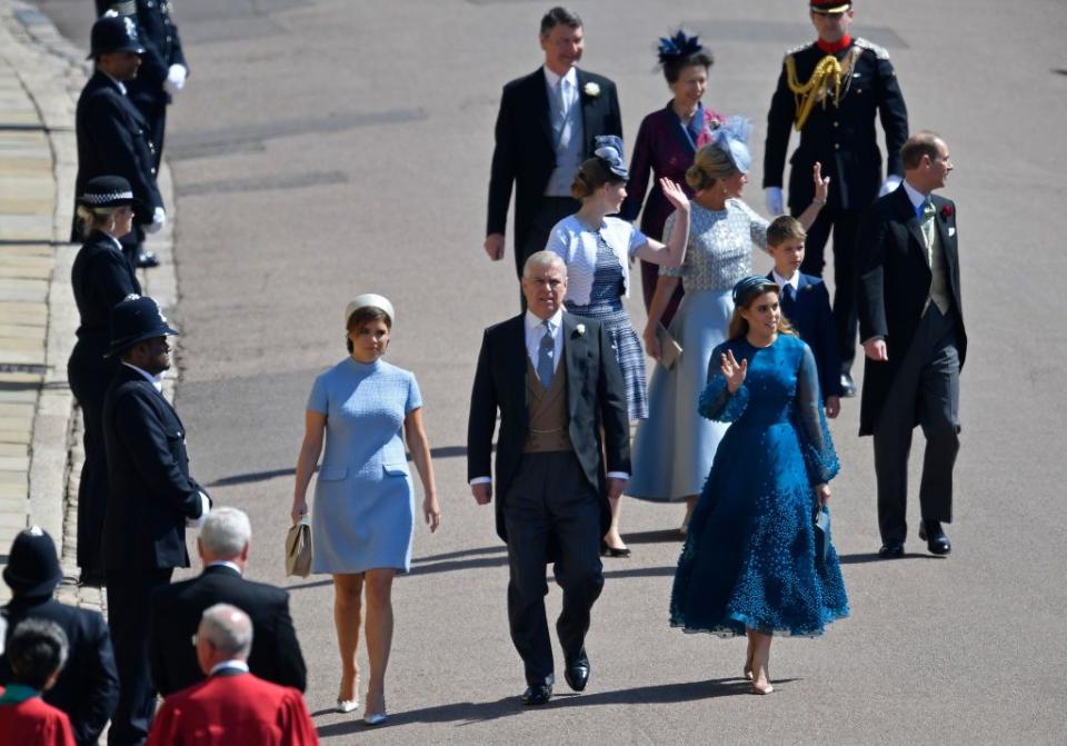 Prince Andrew, Duke of York, and his daughters Princesses Eugenie and Beatrice walk with other members of the royal family.
