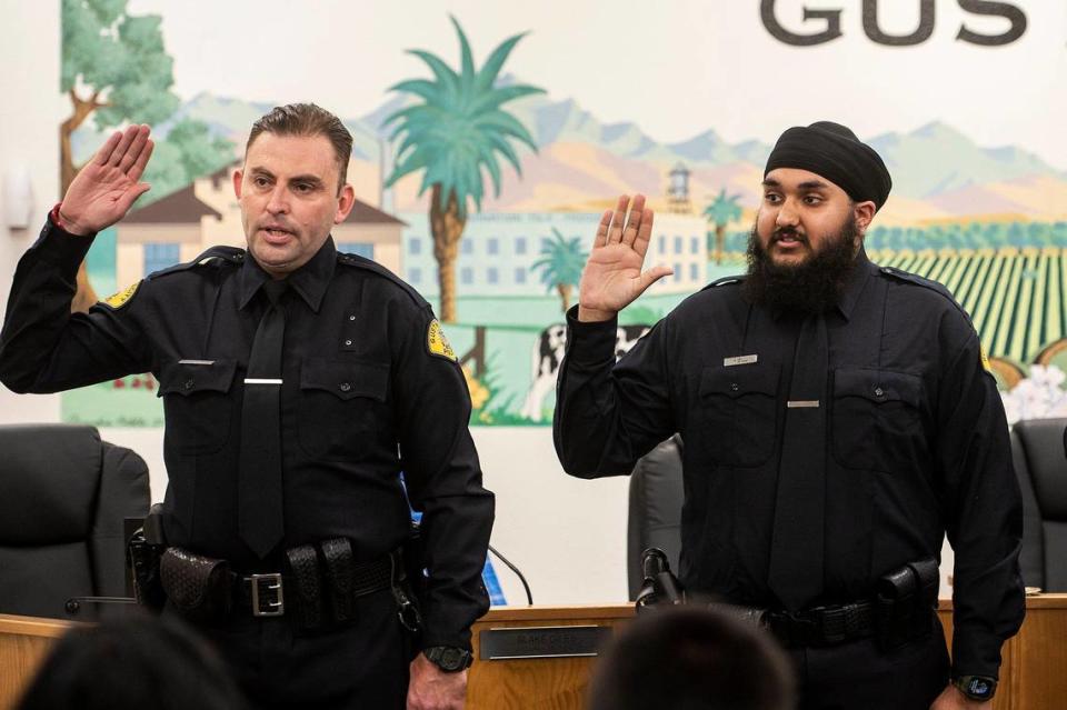 Gustine Reserve Officers Christian Poteat, left, and Harjot Gill, right, are sworn in during a swearing in ceremony for four new Gustine Police Department Reserve Officers in Gustine, Calif., on Tuesday, June 20, 2023. Andrew Kuhn/akuhn@mercedsun-star.com