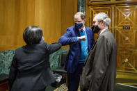 Katherine Tai, nominee for U.S. Trade Representative, greets Senate Finance Committee Chairman Sen. Ron Wyden, D-Oregon, and Sen. Michael Crapo, R-Idaho, right, after the Senate Finance Committee hearing, Thursday, Feb. 25, 2021 on Capitol Hill Washington. (Tasos Katopodis/Pool via AP)