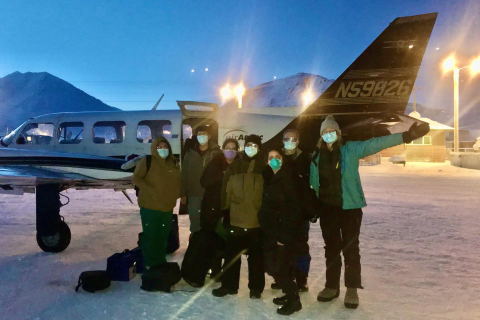 In this undated photo, provided by the Tanana Chiefs Conference, shows a team from the tribal health organization posing outside a plane before leaving for a rural vaccination clinic in Anaktuvuk Pass, Alaska. Some of Alaska's highest vaccination rates among those 16 or older have been in some of its remotest, hardest-to-access communities, where the toll of past flu or tuberculosis outbreaks hasn't been forgotten. (Tanana Chiefs Conference via AP)