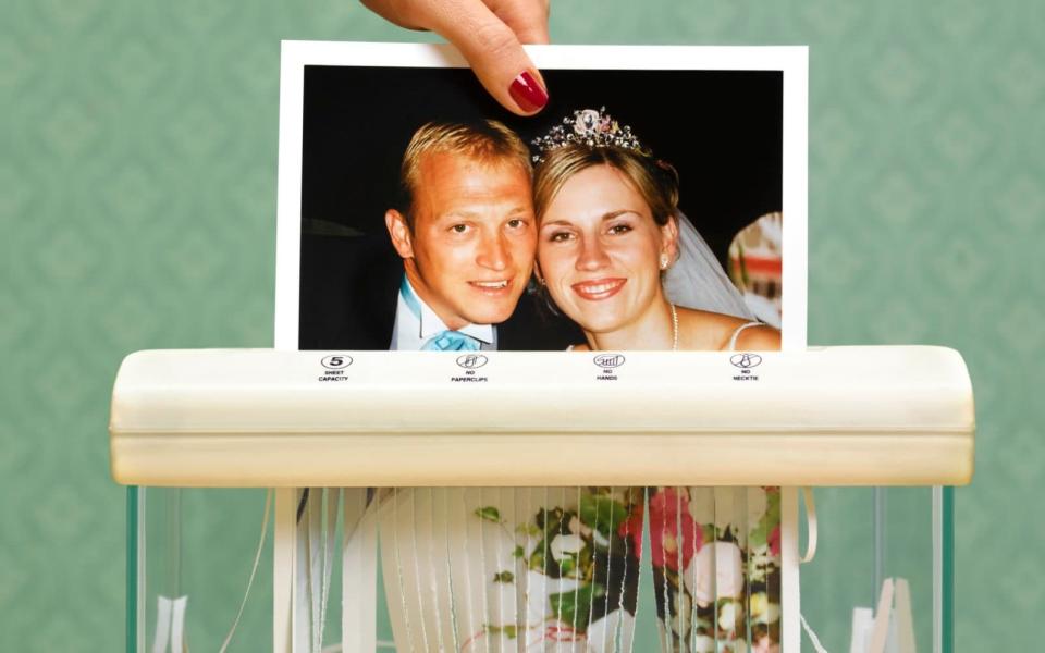 divorced wife shredding wedding photo - Getty Images Contributor