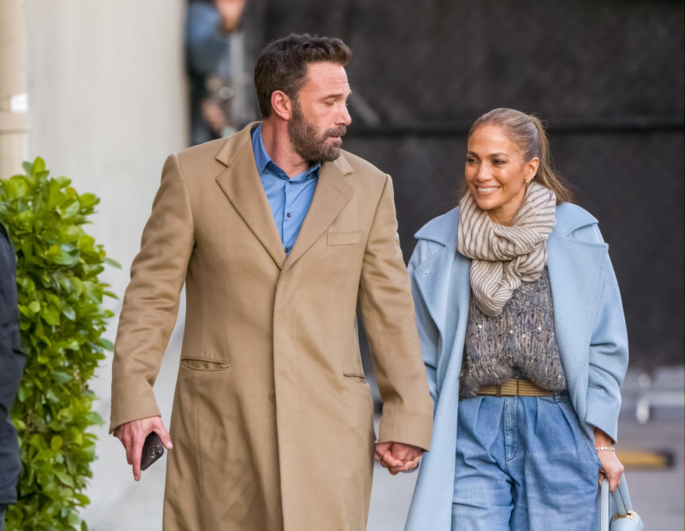 Close-up of JLo and Ben holding hands outside