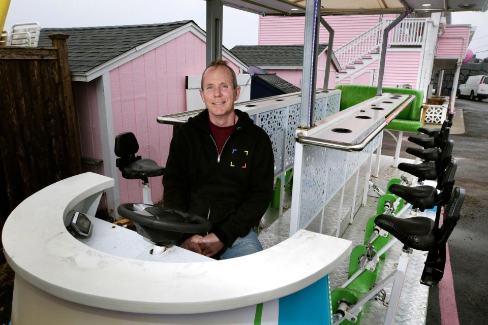 Tom Riley, owner of the Sea Shell Motel in Westerly, sits on his 15-person party bike. Currently, the bike is not permitted on R.I. streets, but proposed legislation seeks to change that.